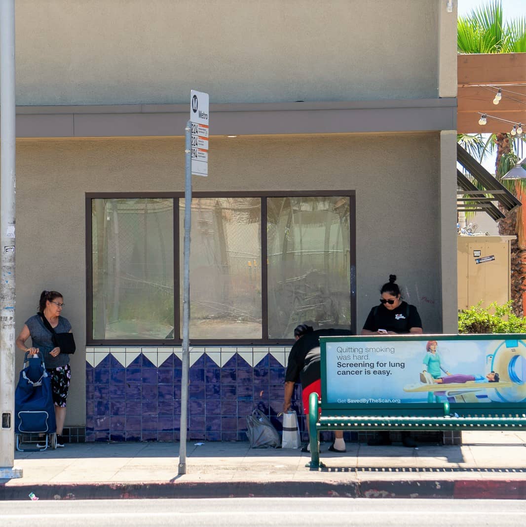 people waiting at traditional bus stop